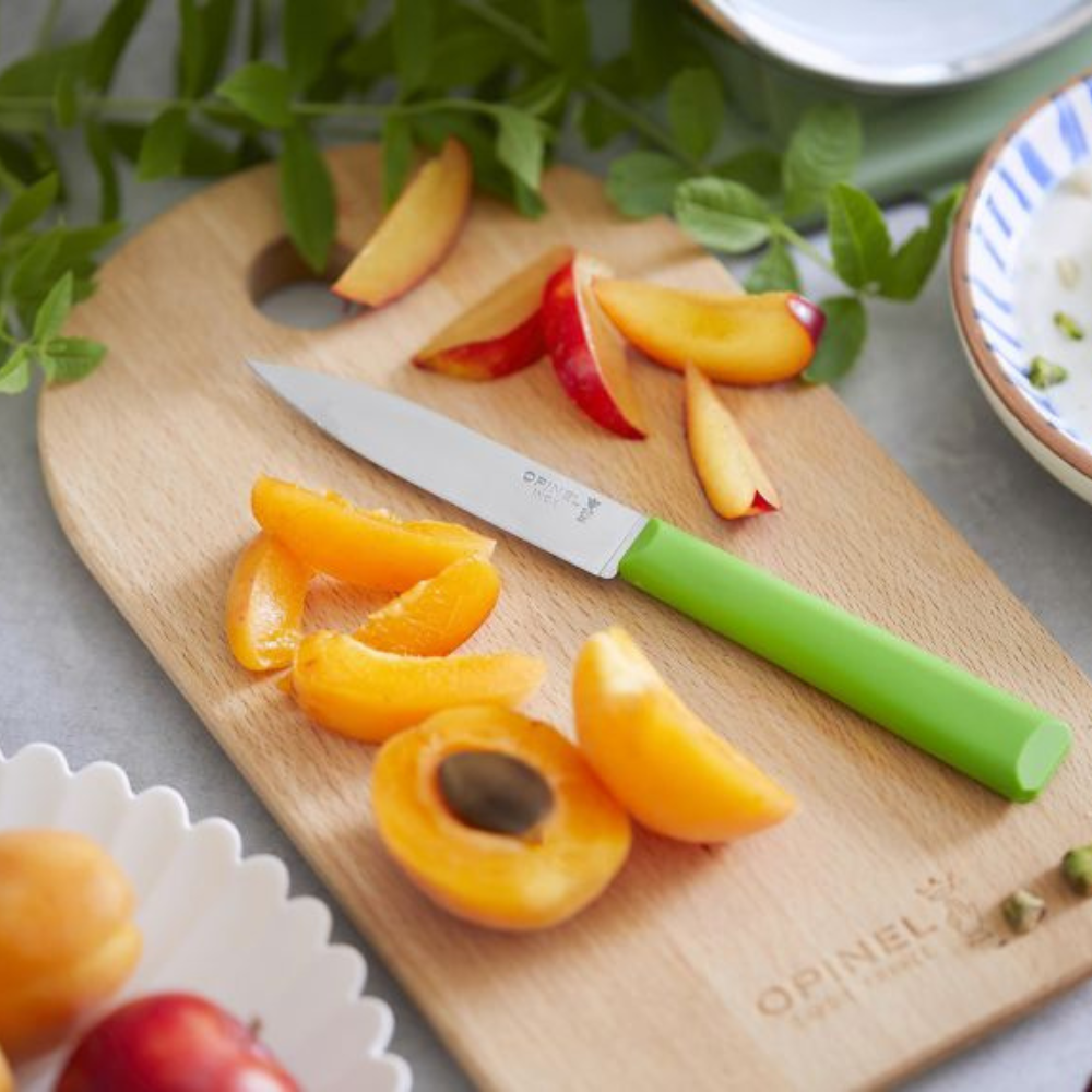 Opinel | N°312 Les Essentiels+ Paring Knife Green on cutting board