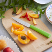Opinel | N°312 Les Essentiels+ Paring Knife Green on cutting board