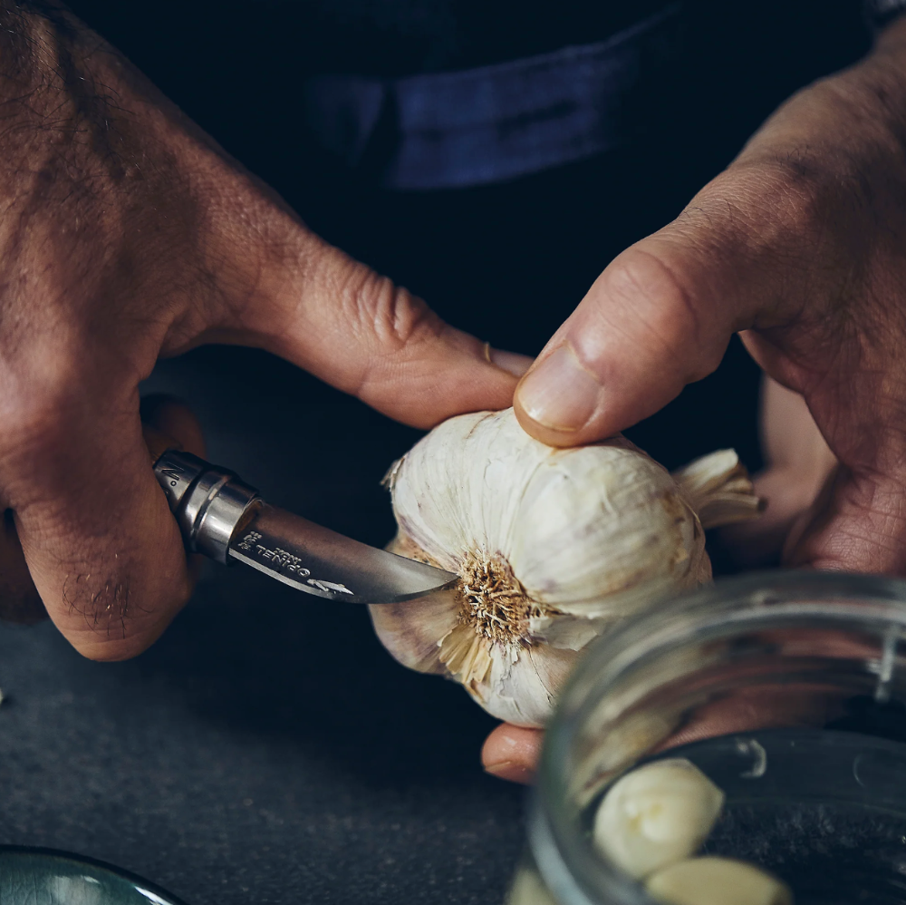 Opinel N°07 Chestnut and Garlic Knife peeling a garlic
